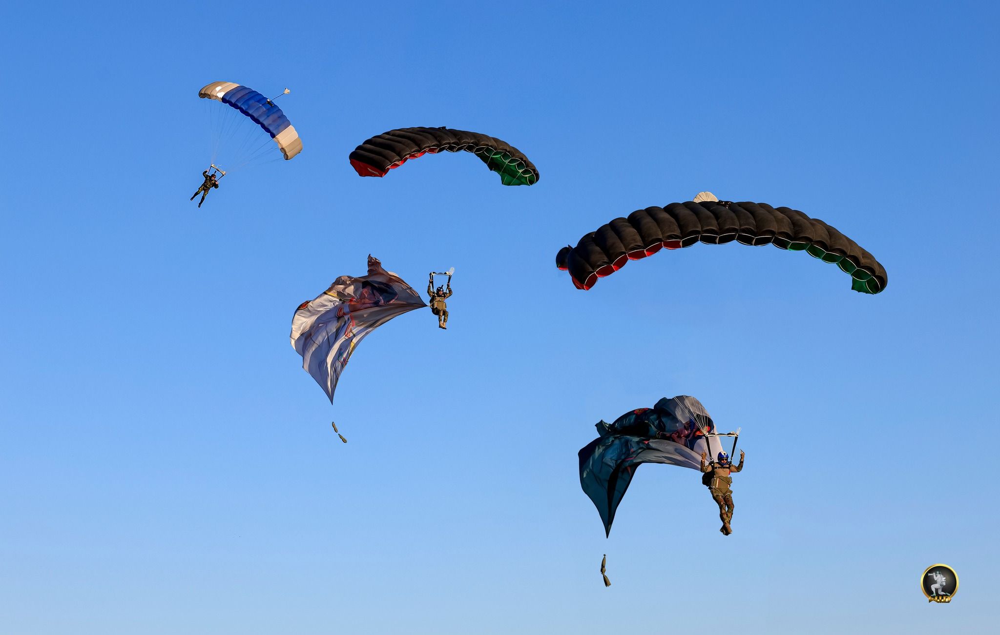 May be an image of 3 people, people skydiving, parasail and text